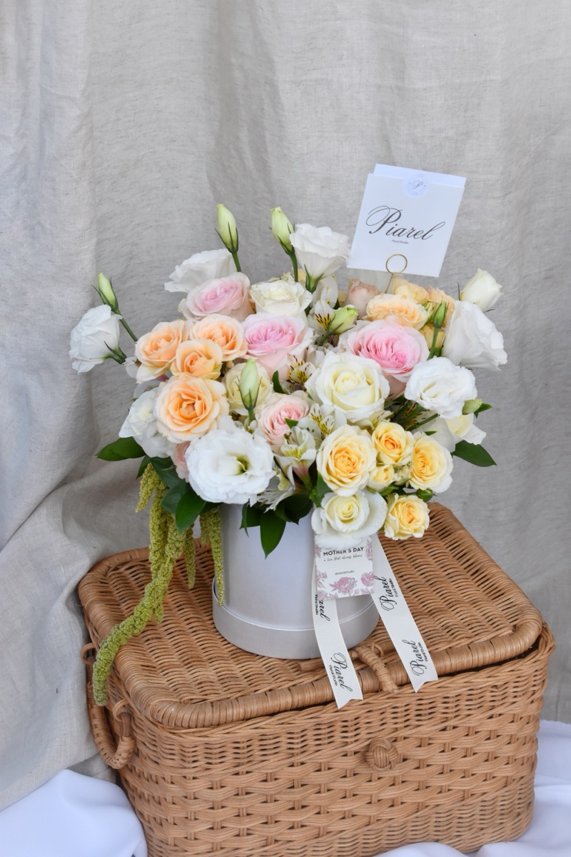 Caja Amor eterno — rosas, lisianthus, mini rosas y astromelia en caja firma con listón Piarel